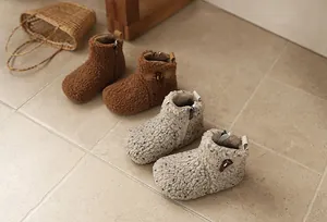 Detailed view of cozy fuzzy winter snow boots for girls in brown and speckled beige.