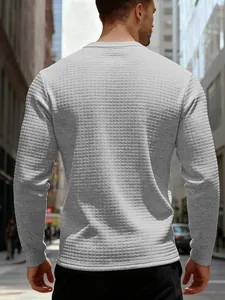 Macro view of the waffle texture on this grey men's slim fit long sleeve sweatshirt