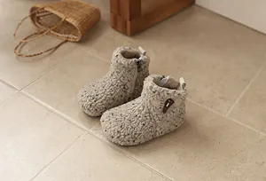 Close-up of cozy fleece-lined toddler boots with toggle button detail and warm lining