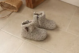Detailed view of warm curly fleece children's snow boots with soft lining and toggle detail.