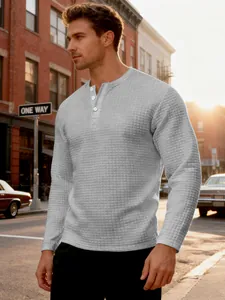 Detailed view of grey men's long-sleeve Henley shirt with vintage waffle texture