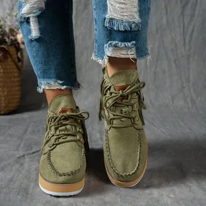 Close-up detail of western style olive green suede fringe ankle boots for women