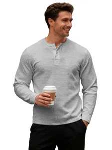 Male model wearing a grey long sleeve Henley shirt featuring a waffle knit texture