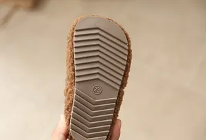 Close-up of anti-slip rubber sole with size 23 on toddler's plush winter snow boot