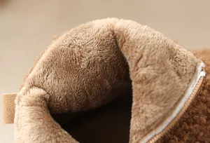 Close-up of soft warm plush lining in winter snow boots for girls with side zipper.