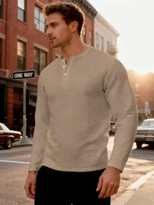 Men's waffle knit long sleeve Henley shirt with retro textured pattern in city setting