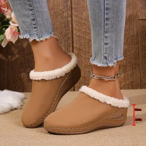 Detail view of 6cm wedge heel on warm plush-lined mules with white fur trim