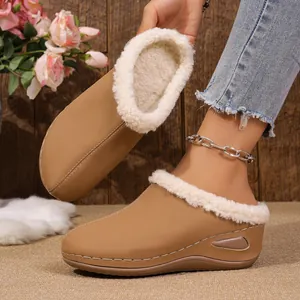 Detailed view of camel wedge slippers featuring cozy faux fur lining and thick comfort sole
