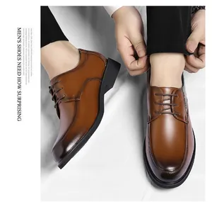 Close-up view of men's brown oxford leather dress shoes in a classic British style.