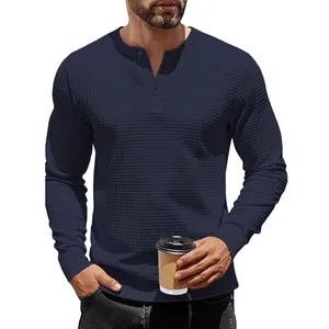 Close-up of navy blue men's Henley shirt featuring a premium jacquard waffle texture