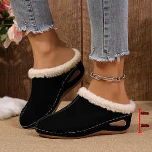 Side detail of black platform wedge slippers showing the 6cm heel height and fur lining