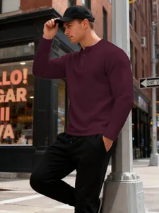 Detailed view of a maroon waffle knit Henley shirt in a stylish urban street setting