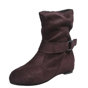 Detail view of dark brown suede slouchy ankle boots with decorative buckle strap.