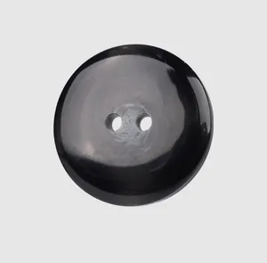 Close-up detail of a premium black resin 2-hole button for high-end clothing.