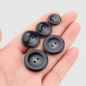 Premium black resin buttons in various sizes for high-end garments and apparel accessories