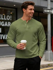Close-up of men's slim fit waffle knit long sleeve Henley sweatshirt in olive green color