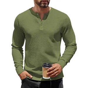 Macro detail of men's olive green long-sleeved waffle knit Henley shirt texture