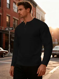 Close-up of black waffle texture men's Henley shirt in an urban street setting