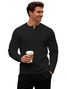 Detail of men's slim fit black long sleeve Henley shirt with waffle knit jacquard texture