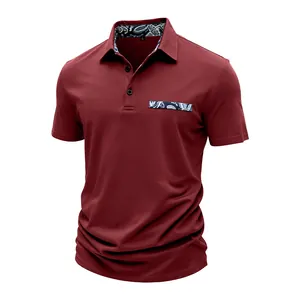 Close-up of maroon men's polo shirt featuring patterned collar lining and pocket detail