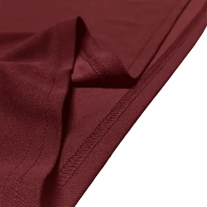 Close-up macro view of the premium burgundy quick-dry fabric and precise stitching