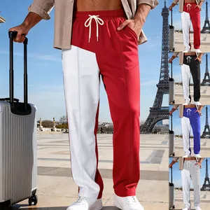 Dettaglio di pantaloni della tuta bicolore da uomo alla moda con design color block rosso e bianco