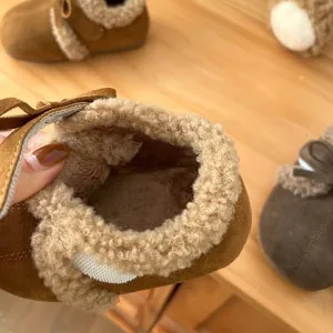 Detalle del forro polar grueso y cálido en los mocasines de gamuza marrón para niños
