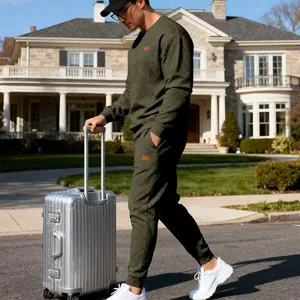 Outdoor lifestyle view of men's olive green jacquard knit sweater and joggers set