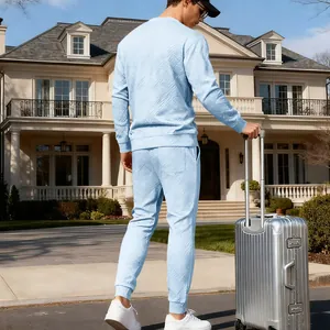 Detail view of the back and texture of men's light blue jacquard knit sweater and joggers