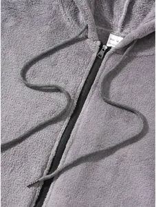 Detailed macro view of grey plush hooded jacket showing zipper and soft fleece material