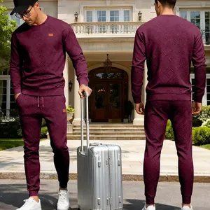Showcasing the geometric jacquard texture and fit of the men's burgundy tracksuit set