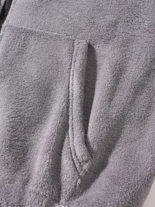 Close-up view of the soft grey fleece texture and pocket stitching of the hoodie