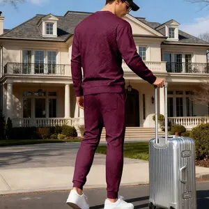 Stylish men's burgundy textured jacquard knit tracksuit with crewneck top and joggers.
