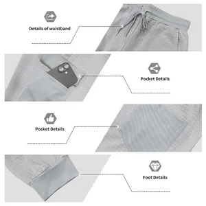 Dettaglio dei pantaloni jogger grigi in maglia a nido d'ape con vita e tasche