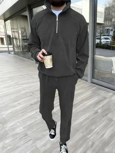 Men's dark grey casual tracksuit set featuring half-zip sweatshirt and matching pants.