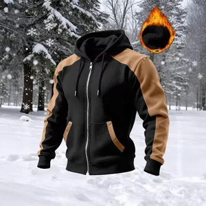 Detailed view of a men's color-block fleece hooded jacket set in a snowy landscape