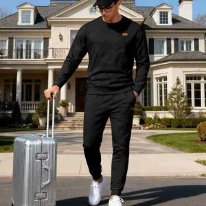 Detailed view of men's black jacquard knit tracksuit in luxury outdoor setting