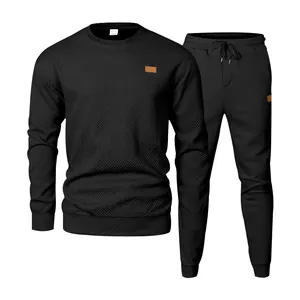 Detailed view of black men's crewneck jacquard knit tracksuit set with textured fabric