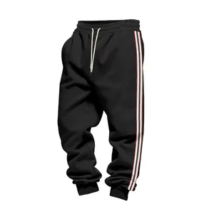 Close-up of men's black fleece joggers featuring side stripes and elastic cuffs
