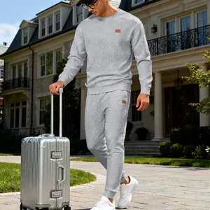 Detail view of grey jacquard knit tracksuit worn by model in a travel lifestyle setting