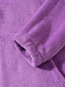 Close-up of soft purple polar fleece jacket showing fabric texture and sleeve cuff detail.