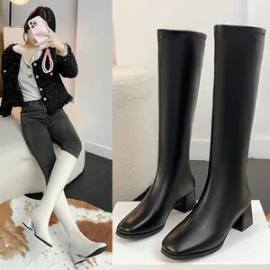 Detailed view of black square toe knight boots featuring a stable chunky mid-heel