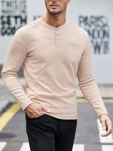 Close-up of casual beige long-sleeve Henley shirt with waffle texture and pocket.