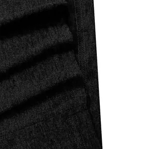 Macro detail showing the texture and durable stitching of a black heathered Henley shirt.