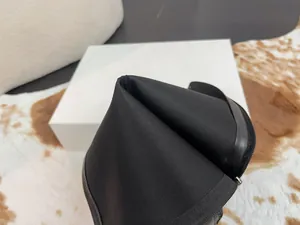 Close-up detail of the soft interior lining and side zipper of black leather tall boots