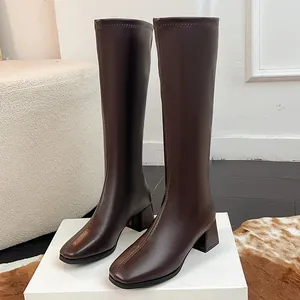 Detailed view of dark brown square-toe knee-high boots with stable chunky heel