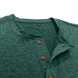 Close-up of green men's Henley shirt collar with brown buttons and breathable fabric texture.