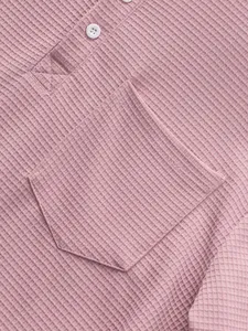 Close-up of pink waffle knit fabric on long-sleeve Henley shirt with pocket detail