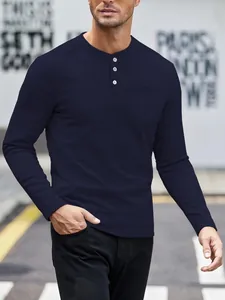 Detailed view of men's navy blue waffle knit henley shirt with button neckline