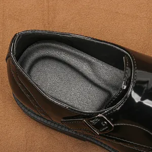 Primo piano di scarpa monk in pelle verniciata nera con fibbia e suola testurizzata